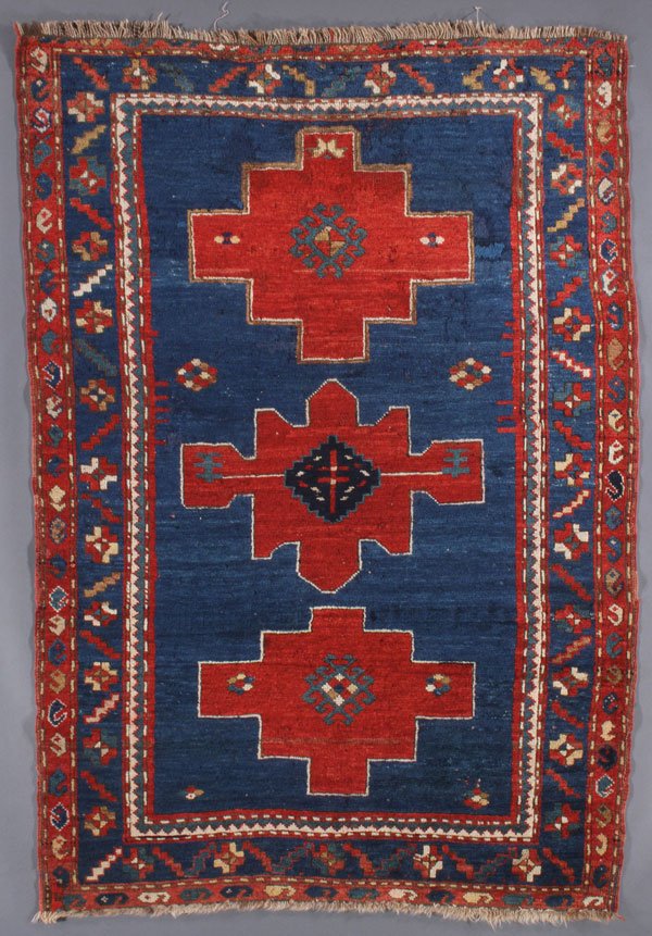A CAUCASIAN RUG, CIRCA 1900-1910: A CAUCASIAN RUG, CIRCA 1900-1910. 3 feet 11 inches x 5 feet 7 inches (119.4 x 170.2 cm). Provenance: From the lifetime estate collection of Jose Antonio Danobeitia (1942-2011). Born in Spain, Mr. Dano