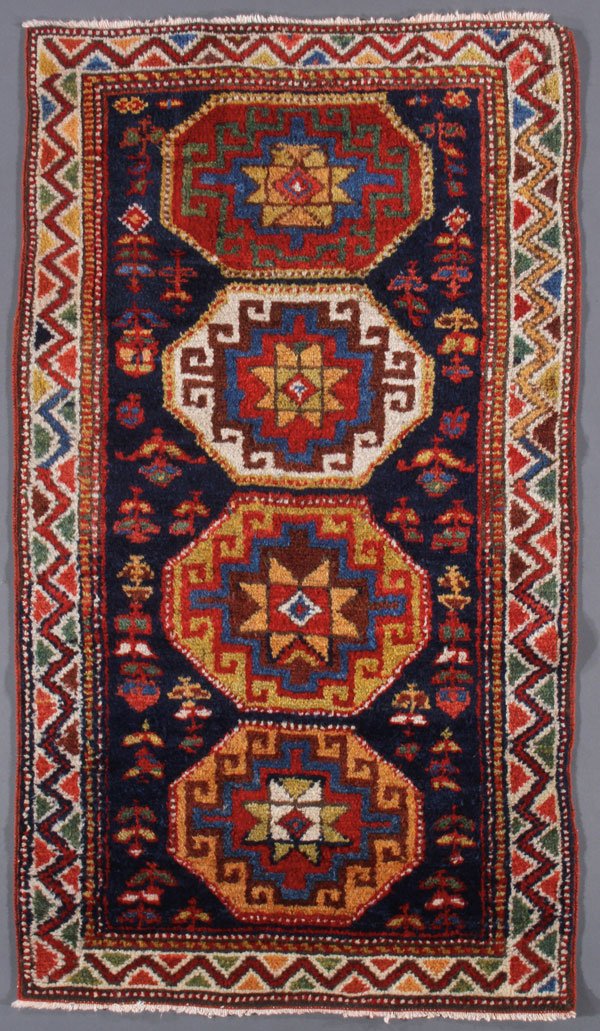 A GENJE KAZAK ORIENTAL RUG, SOUTHWEST CAUCASUS: A GENJE KAZAK ORIENTAL RUG, SOUTHWEST CAUCASUS, FIRST QUARTER 20TH CENTURY. 2 feet 5 inches x 4 feet 3 inches (73.7 x 129.5 cm). Provenance: From the lifetime estate collection of Jose Antonio Danobei