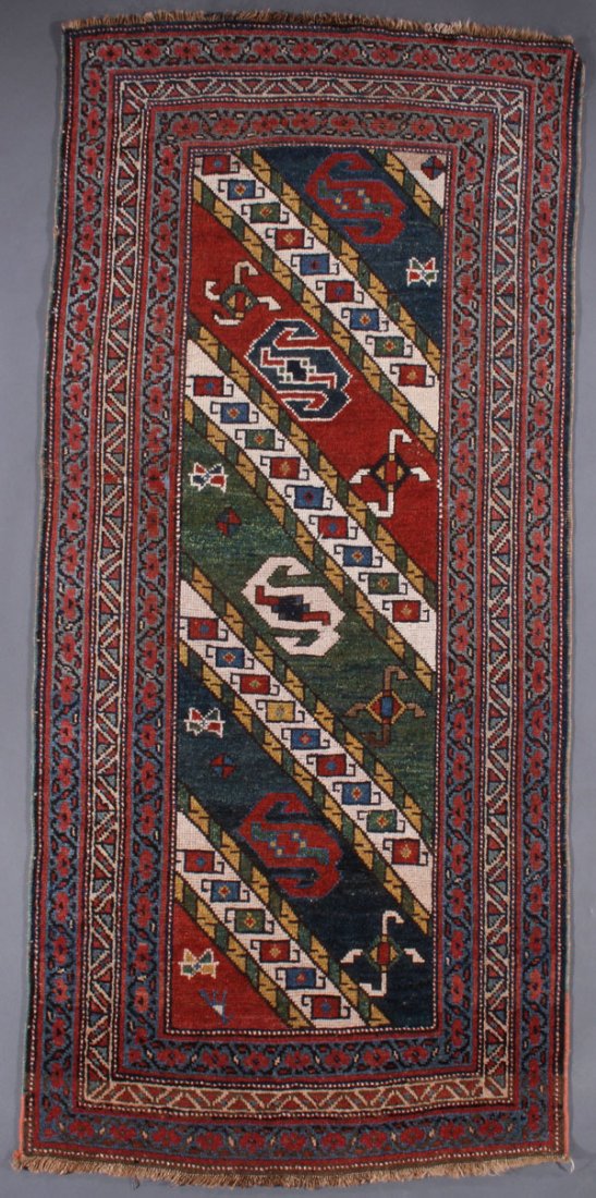 A CAUCASIAN KAZAK RUG, SECOND QUARTER 20TH C: A CAUCASIAN KAZAK RUG, SECOND QUARTER 20TH CENTURY. 3 feet 5 inches x 8 feet 6 inches (104.1 x 259.1 cm). Provenance: From the lifetime estate collection of Jose Antonio Danobeitia (1942-2011). Born i