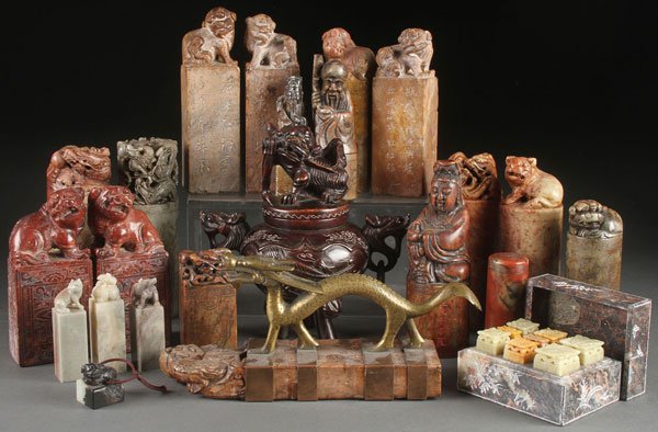 29 ASIAN FINELY CARVED STONE SEALS & MORE: A COLLECTION OF 29 ORIENTAL CARVED STONE SEALS AND CHOPS. Mostly carved soapstone of various form and size and surmounted with Buddhist figures, Foo-dogs and lions, the squared or cylindrical bases in