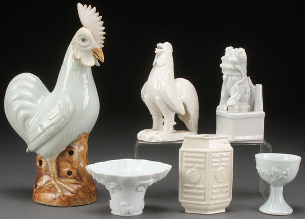 AN EIGHT PIECE GROUP OF CHINESE WHITE AND CELADON: AN EIGHT PIECE GROUP OF CHINESE WHITE AND CELADON GLAZED PORCELAIN, 19TH/20TH CENTURY WITH SOME POSSIBLY EARLIER. Comprising a figure of a standing rooster, a blanc de chine crowing rooster and Foo-do