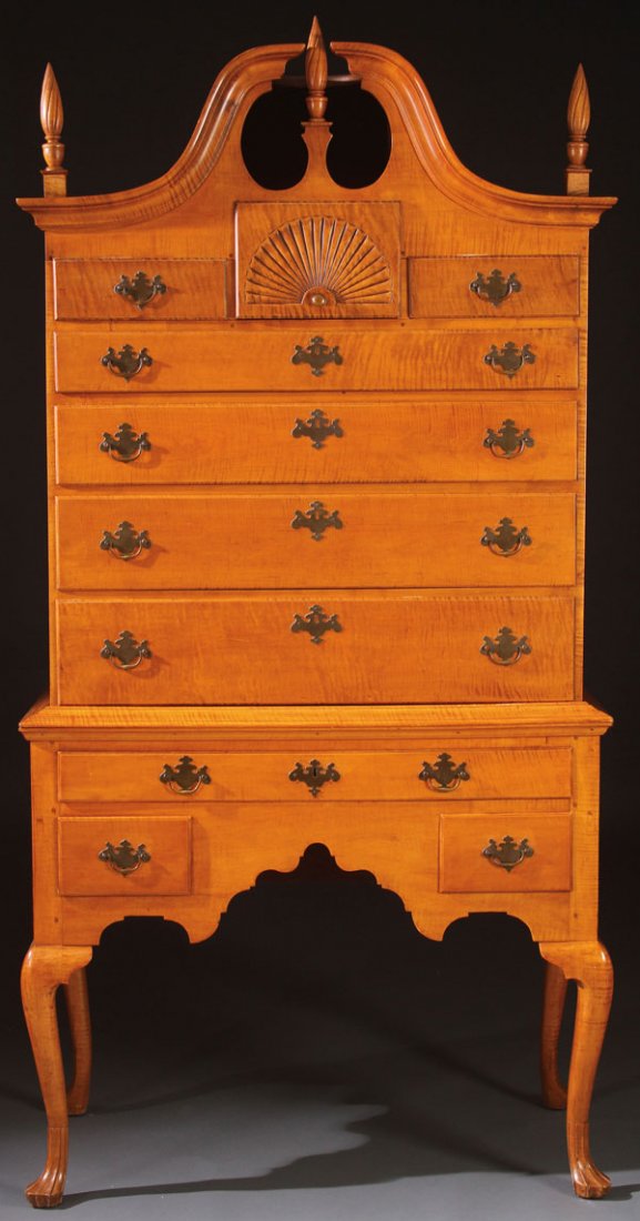 AMERICAN QUEEN ANNE MAPLE BONNET TOP HIGH BOY: AN AMERICAN QUEEN ANNE TIGER STRIPE MAPLE BONNET TOP HIGHBOY, PERHAPS CONNECTICUT, 18TH/19TH CENTURY OR LATER. The upper seven drawer case with central fan carved drawer below a finely arched bonnet t