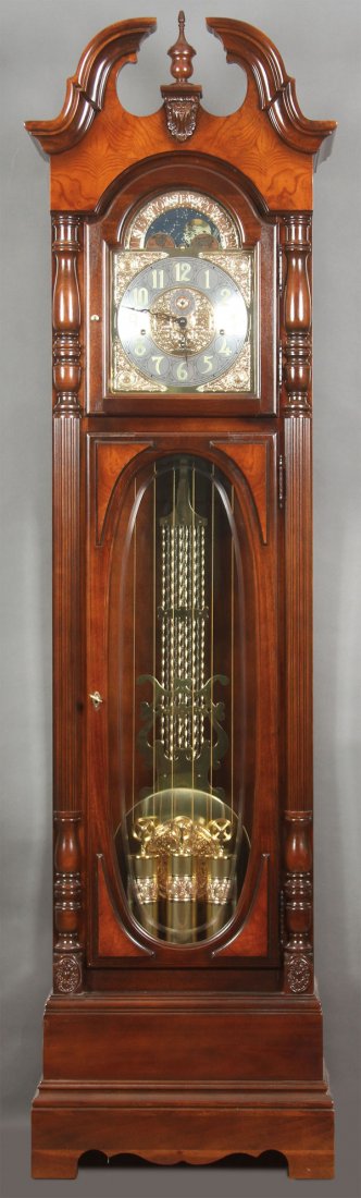 HOWARD MILLER "ROBINSON" TALL CASE FLOOR CLOCK: A FINE HOWARD MILLER "ROBINSON" TALL CASE FLOOR CLOCK, CIRCA 2007. The cherry Bordeaux finished cabinet with olive ash burl accents below a broken pediment arched top containing a cable-driven, triple