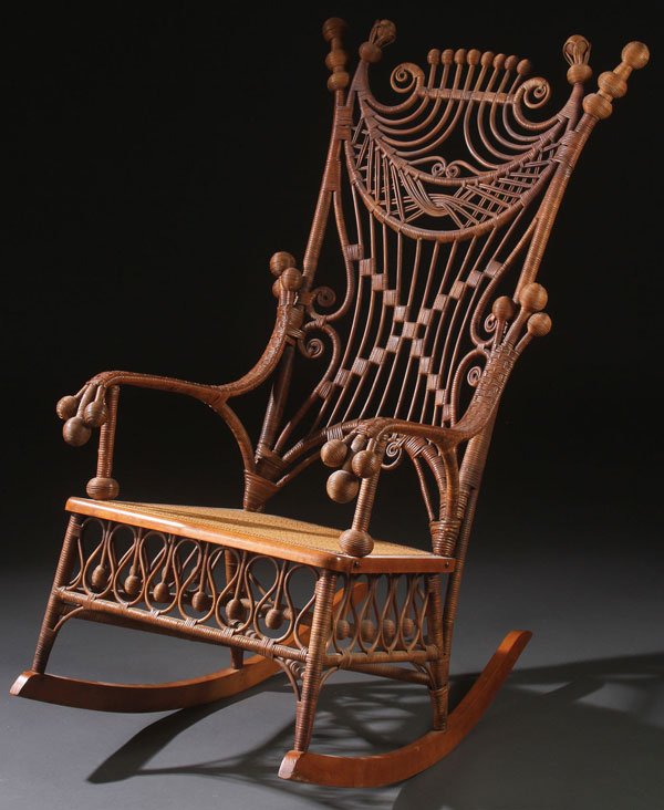 HEYWOOD & MERRIL RATTAN CO. ROCKER: A VERY FINE HEYWOOD & MERRIL RATTAN CO. STICK AND BALL ROCKER, CIRCA 1900. The high back seat elaborately wrapped and decorated with interwoven rattan bent scroll work and fluted ball finials raised o