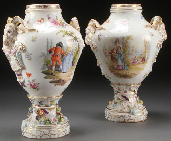 PAIR OF CARL THIEME HAND PAINTED PORCELAIN VASES: A PAIR OF CARL THIEME HAND PAINTED PORCELAIN VASES, CIRCA 1900. Each with hand painted romantic courting scenes, floral sprays flanked by figural rams head handles, one with loss to horn, lids absent.