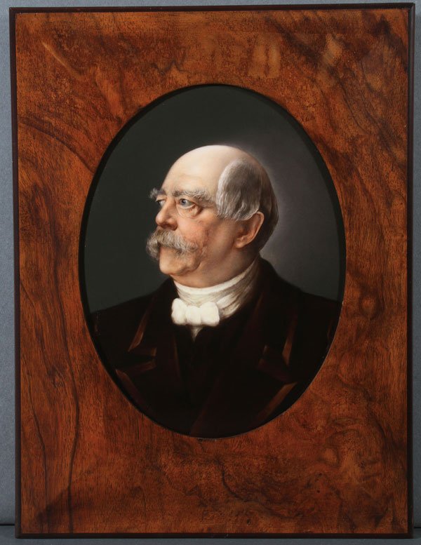A HANDPAINTED KPM STYLE OVAL PORCELAIN PLAQUE: A HANDPAINTED KPM STYLE OVAL PORCELAIN PLAQUE, CIRCA 1890. Depicting a bust portrait of Chancellor Otto Von Bismarck, finely painted and contained in an attractive walnut frame, verso of porcelain pla