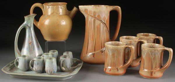 A DENBAC (DENERT & BALICHON) FRENCH ART POTTERY: A DENBAC (DENERT & BALICHON) FRENCH ART POTTERY GROUP, EARLY 20TH CENTURY. Comprising a nine piece cordial set with ewer, 7 handled mugs and tray, a four piece beverage set and a handled jug with embo
