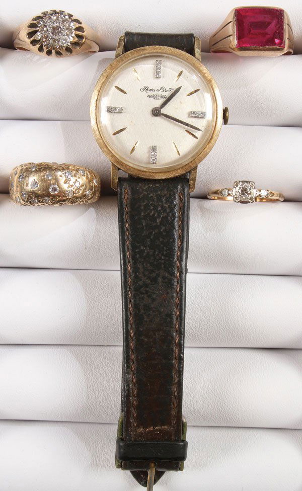 A MAN'S GOLD WATCH AND GOLD RINGS WITH GEMSTONES: A MAN'S GOLD WATCH AND GOLD RINGS WITH GEMSTONES GROUP, 20TH CENTURY. Comprising a 14k Henri Pirot wrist watch with diamond accented numerals and 17 jewel movement contained in a 14k case, an unmarke