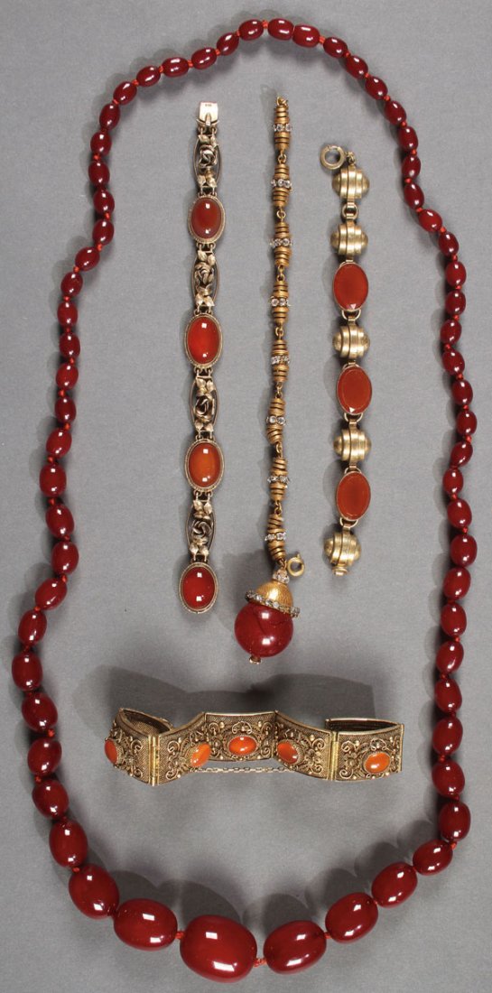 A FIVE PIECE GROUP OF VINTAGE AMBER AND CARNELIAN: A FIVE PIECE GROUP OF VINTAGE AMBER AND CARNELIAN AGATE JEWELRY GROUP. Comprising a coiled wire bracelet stamped silver, a 935 silver bracelet with floral links and agate cabochons, and an amber neckl