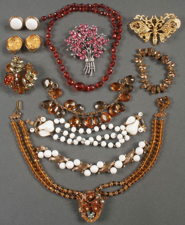 A THIRTEEN PIECE GROUP OF BETTER COSTUME JEWELRY: A THIRTEEN PIECE GROUP OF BETTER COSTUME JEWELRY. Comprising two white Trifari bracelets, a pair of Nettie Rosenstein classical earrings, a Hattie Carnegie brooch, a Trifari floral form brooch and ot