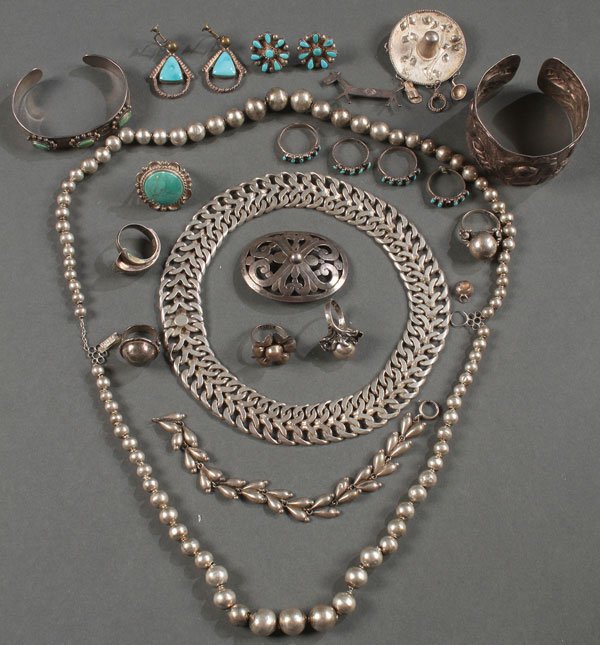 A TWENTY-TWO PIECE GROUP OF SOUTHWEST NATIVE: A TWENTY-TWO PIECE GROUP OF SOUTHWEST NATIVE AND MEXICAN SILVER JEWELRY, 20TH CENTURY. Comprising a large flat woven choker, a sombrero form pin, a repousse floral bracelet, assorted finger rings earr