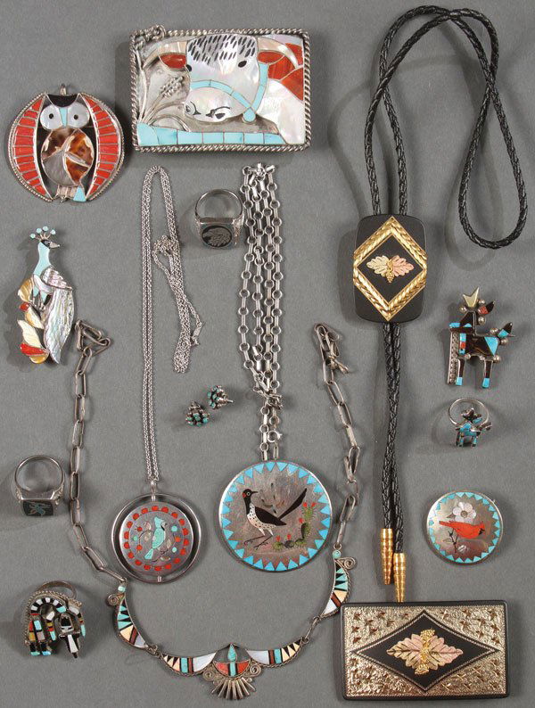 A FOURTEEN PIECE GROUP OF SOUTHWESTERN ZUNI SILVE: A FOURTEEN PIECE GROUP OF SOUTHWESTERN ZUNI SILVER INLAID JEWELRY, 20TH CENTURY. Comprising a steer head belt buckle stamped "H-L ZUNIE", an owl form pin inscribed "ROSE BOBLU 1977", a peacock pin in