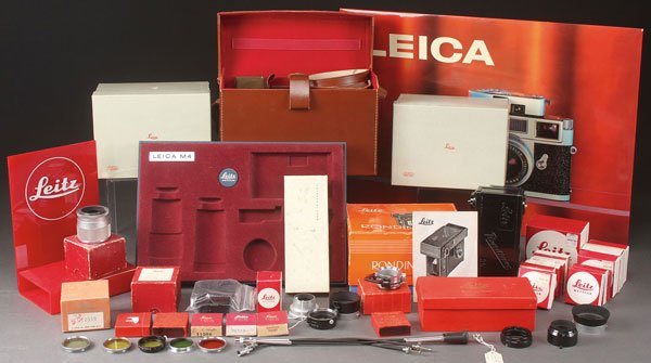 A VINTAGE LEICA ACCESSORIES GROUP, MID-20TH: A VINTAGE LEICA ACCESSORIES GROUP, MID-20TH CENTURY. Comprising a Benser leather compartment case, a Rondinax film tank in original box, various shutter release cables, extension tubes, shades, filter