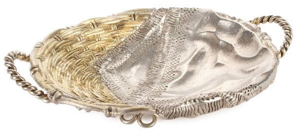 RUSSIAN SILVER TROMPE L'OEIL TRAY, 1874: A RUSSIAN SILVER GILT TROMPE L’OEIL CANDY TRAY, MOSCOW, 1874. Resting on a twisted wire foot and overall repousséd and chased in a basket weave pattern and partially overlaid with a faux linen napk