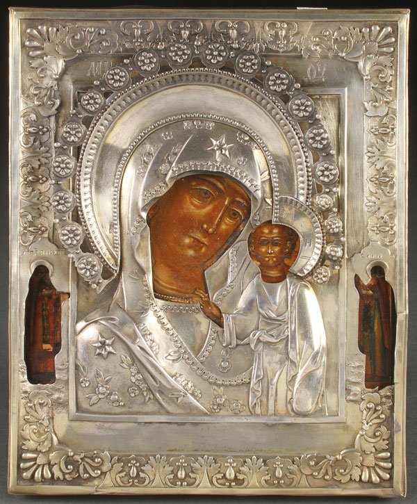 RUSSIAN ICON, CIRCA 1850: A RUSSIAN ICON OF THE KAZAN MOTHER OF GOD, CIRCA 1850. The borders with Saints Paisiy and Anna. Overlaid with a heavy, silver, repoussé, and chased riza with indistinguishable mark. 9.1 inches x 7.5 