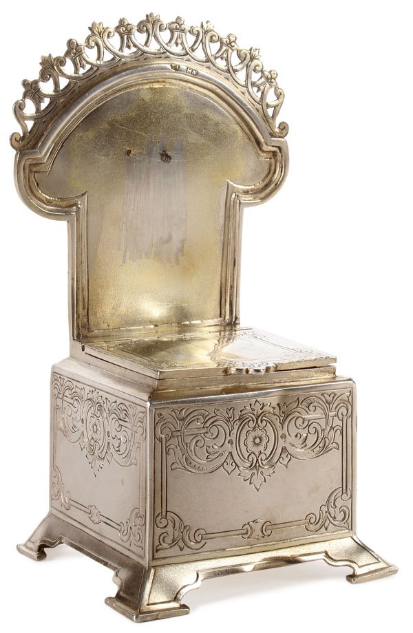 RUSSIAN SILVER SALT THRONE: A RUSSIAN SILVER GILT AND ENGRAVED SALT THRONE, MOSCOW, 1896. Resting on four raised feet, the sides engraved with strapwork and flowerforms, the back rest with pierced rail and the hinged seat openin
