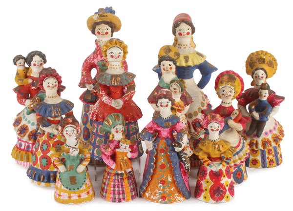 12 RUSSIAN FOLK ART DYMKOVO DOLLS, CIRCA 1930: A GROUP OF 12 RUSSIAN FOLK ART DYMKOVO DOLLS, CIRCA 1930’S. Comprising 12 women painted in colorful attire including feathered hats, bonnets, kokosniki and elaborate dresses each traditionally manuf