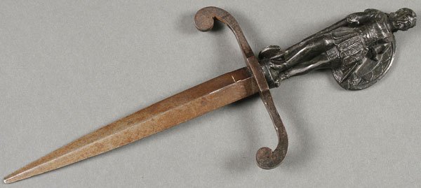 INTERESTING VICTORIAN BRONZE GENTLEMAN’S DAGGER: AN INTERESTING LATE VICTORIAN BRONZE GENTLEMAN’S DAGGER. The cast figural handle depicting an armor clad guard holding shield and axe and set with a tapering double edged triangular blade. Length 1