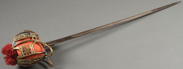 SCOTTISH BASKET-HILTED BROAD SWORD: A SCOTTISH HIGHLANDER NCO OFFICERS BASKET-HILTED BROAD SWORD, CIRCA 1900. The hilt with pierced brass basket, wire wrapped leather handle, red felt liner and silk tasseled pommel, the blade stamped ��