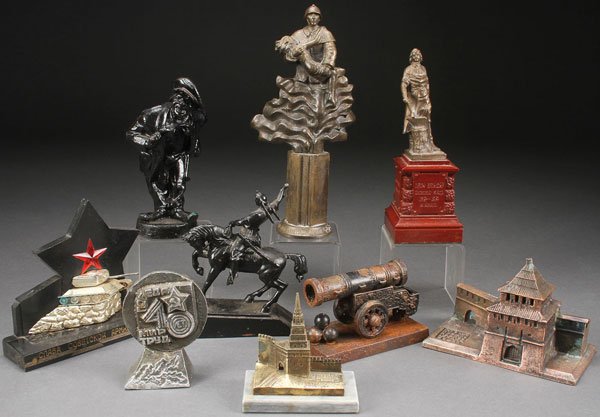RUSSIAN SOVIET SCULPTURES: A GROUP OF RUSSIAN SOVIET PERIOD CAST SCULPTURES, VARIOUS MATERIALS, CIRCA 1970-1995. Comprising patriotic figures Peter the Great, the Tsar Cannon, a Fireman Rescuing a Child, and others. Greatest he