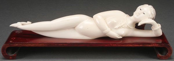 CHINESE CARVED IVORY DOCTOR'S LADY FIGURE, C 1920: A FINE CHINESE CARVED IVORY “DOCTOR’S LADY” FIGURE, CIRCA 1920. Depicting a reclining nude woman carved with a necklace and loose ring bracelet. Length 8.25 inches (20.5 cm). The offered lot is 