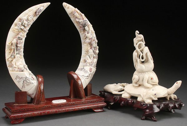 3 PC GROUP CHINESE CARVED IVORY, CIRCA 1950: A THREE PIECE GROUP OF CHINESE CARVED IVORY, CIRCA 1950. Comprising a pair of boar tusks each carved with figures of Immortals and with incised scenic panels and inscriptions on verso and a figural gr