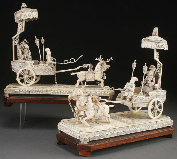 A PAIR OF CHINESE CARVED IVORY CARRIAGE GROUPS: A PAIR OF LARGE CHINESE CARVED IVORY AND BONE IMPERIAL CARRIAGE GROUPS, CIRCA 1925. One with an Emperor and one with an Empress each of matching form and decoration, the figures mounted in a two wheel