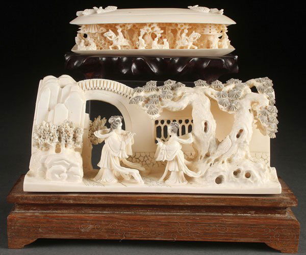 A FINE PAIR OF ORIENTAL CARVED IVORY ORNAMENTS: A FINE PAIR OF ORIENTAL CARVED IVORY ORNAMENTS, CIRCA 1950. Comprising a well carved Chinese scene of two dancing women with attendant fully carved in the round and pierced with pine trees extending f