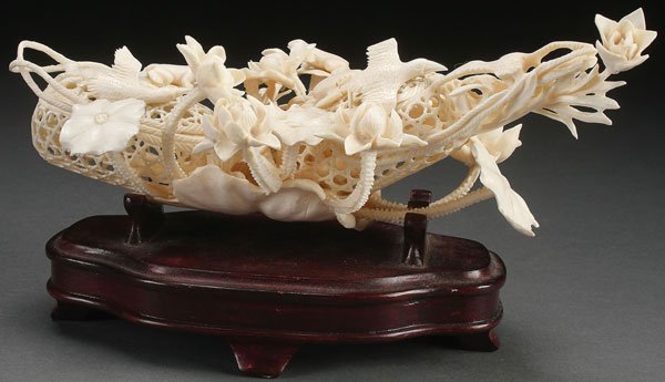 A FINE CHINESE CARVED IVORY FIGURAL GROUP: A FINE CHINESE CARVED IVORY FIGURAL GROUP, CIRCA 1920. Well carved and pierced in good detail modeled as two fishing baskets each containing crabs and further mounted with extending lily pads, lotus b