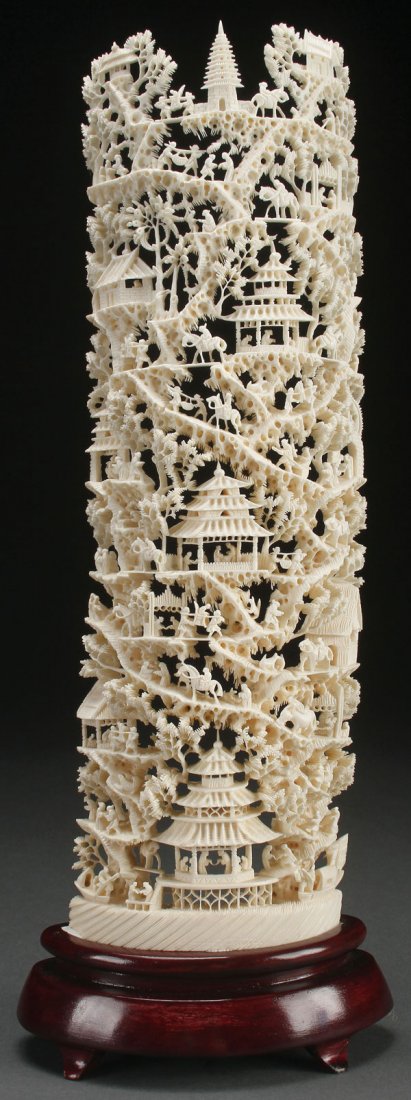 A CHINESE CARVED IVORY SCENIC TUSK, CIRCA 1950: A CHINESE CARVED IVORY SCENIC TUSK, CIRCA 1950. The half round section fully carved and pierced with an elaborate scene of pavilions, figures, equestrian riders and pine tree foliage in miniature rais