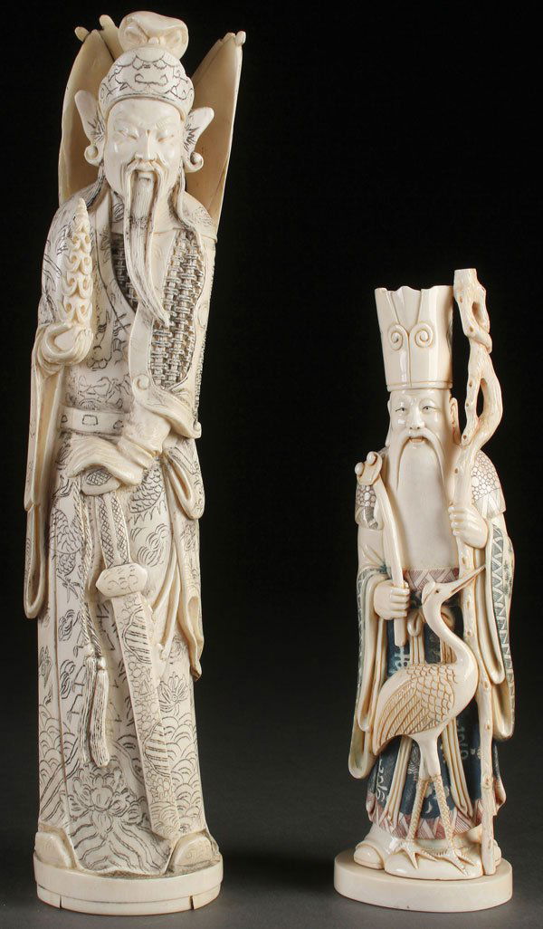 A PAIR OF ORIENTAL CARVED IVORY FIGURES: A PAIR OF ORIENTAL CARVED IVORY FIGURES, CIRCA 1950. Comprising a Chinese general with finely incised dragon robe, sword and attached flags and an Immortal with polychrome decorated garments, pierced