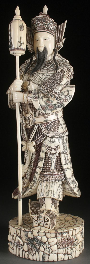 CHINESE CARVED BONE & IVORY FIGURE OF A WARLORD: A LARGE CHINESE CARVED BONE AND IVORY FIGURE OF AN ARCHAIC WARLORD, CIRCA 1950. Decorated with an elaborate suit of armor with incised and polychrome designs. Height 22.25 inches (51.4 cm). The offere