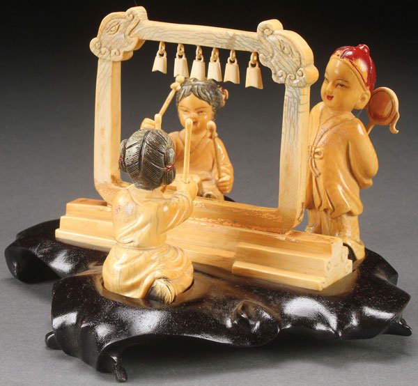 A CHINESE CARVED IVORY FIGURAL GROUP, CIRCA 1920: A CHINESE CARVED IVORY FIGURAL GROUP, CIRCA 1920. Each modeled as separate figures and carved as various musicians with central instrument of suspended bells and raised on a fitted hardwood stand. Tot