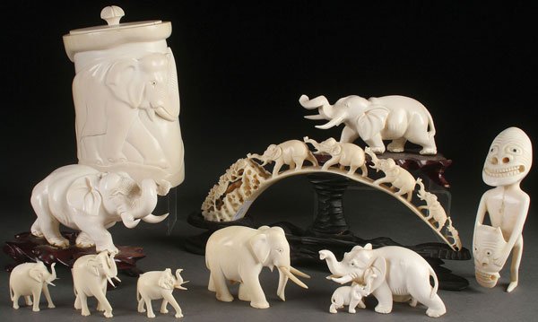 A TEN PIECE GROUP OF CARVED IVORY, CIRCA 1950: A TEN PIECE GROUP OF CARVED IVORY, CIRCA 1950 AND EARLIER. The majority of figural elephants comprising two well carved trumpeting figures with curled trunks, a carved boars tusk with five parading el