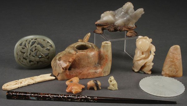 AN EIGHT PIECE GROUP OF CHINESE CARVED SOAPSTONE: AN EIGHT PIECE GROUP OF CHINESE CARVED SOAPSTONE ORNAMENTS, 20TH CENTURY. Comprising a melon shaped coupe with pin rest, a reticulated plaque, a reclining Immortal, a figure of an infant, three miniat