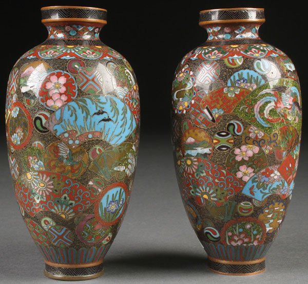 A PAIR OF JAPANESE CLOISONNE BRONZE VASES, MEIJI: A PAIR OF JAPANESE CLOISONNE BRONZE VASES, MEIJI PERIOD. Each decorated with a complex and intricate scene of florals and scenery in various fan and circular shapes on a coiled diaper ground, base of 
