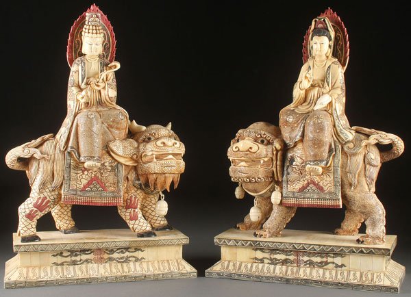 PR OF LARGE CHINESE CARVED FIGURAL GROUPS: A PAIR OF LARGE CHINESE CARVED AND POLYCHROME FIGURAL GROUPS, 20TH CENTURY. Depicting a figure of Buddha sitting atop a horned mythical beast holding an orb and ruyi scepter and a figure of Kwan-Yin w