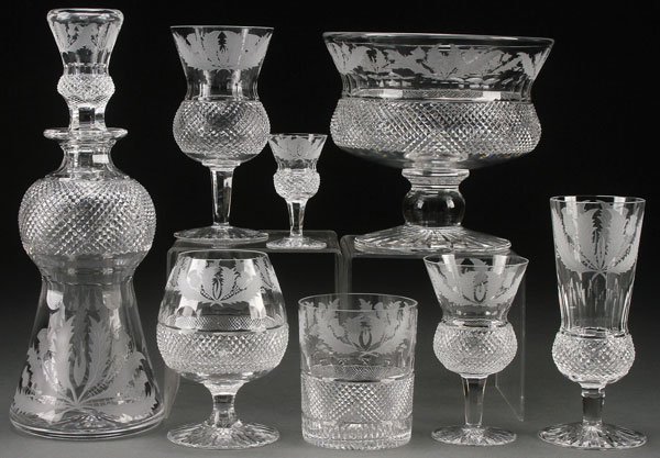 38 PC SET EDINBURG SCOTTISH "THISTLE" CRYSTAL: A 38 PIECE SET OF EDINBURG SCOTTISH “THISTLE” ETCHED AND CUT CRYSTAL, EARLY 20TH CENTURY. Comprising a 12 inch decanter, 7 inch diameter compote and 6 each; 6.75 inch fluted champagnes, 6.5 inch g