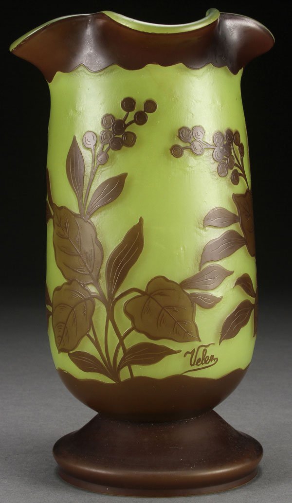 A VELEZ CAMEO ART GLASS VASE, EARLY 20TH CENTURY: A VELEZ CAMEO ART GLASS VASE, EARLY 20TH CENTURY, PROBABLY BY LOETZ. In a lime colored glass, overlaid with topaz, cut with the design of leafy branches and berries. Signed in cameo “VELEZ”. Heig