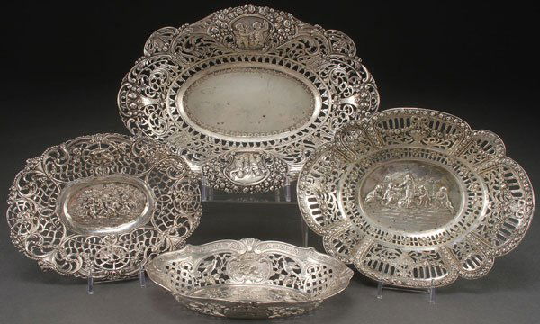 FOUR HANAU STYLE SILVER SCENIC BOWLS, GERMANY: A GROUP OF FOUR HANAU STYLE SILVER BOWLS, GERMANY, CIRCA 1900. Each of oval form and various size with embossed and reticulated Neo-Classic scenes of cupids or putti and florals. All with Hanau style
