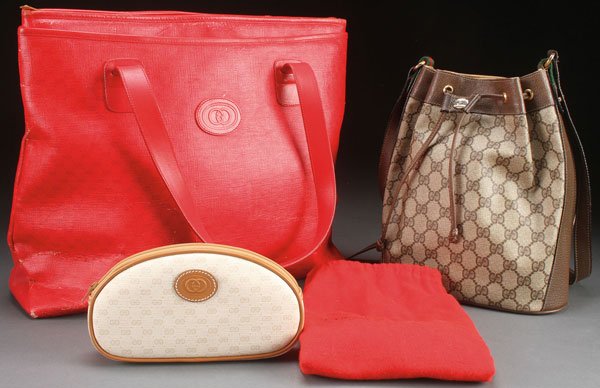 A GROUP OF THREE GUCCI HANDBAGS.: A GROUP OF THREE GUCCI HANDBAGS. Comprising a red leather handbag with strap handles and natural pig skin leather, a canvas and leather strap "Accessory Collection" shopping bag style 810, a leather "