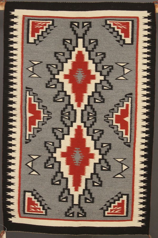 4 SOUTHWEST NATIVE AMERICAN HAND WOVEN RUGS: A GROUP OF FOUR SOUTHWEST NATIVE AMERICAN HAND WOVEN RUGS, LAST QUARTER 20TH CENTURY. Of various design including Storm pattern and Yeibachi. Ranging from 45 inches x 30 inches to 51 inches x 33 inche