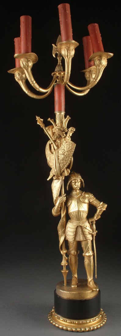 A FRENCH GILT BRONZE GOTHIC REVIVAL FIGURAL CANDELABRA: A FRENCH GILT BRONZE GOTHIC REVIVAL FIGURAL CANDELABRA OF A PALACE GUARD, 19TH CENTURY. Dressed in full armor, raised on a black slate plinth, some disrepair. Height 31.75 inches (81 cm).