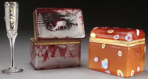 THREE PIECES OF CONTINENTAL ART GLASS: A THREE PIECE GROUP OF CONTINENTAL ART GLASS. Comprising a Bohemian ruby etched dresser box, early 20th c, a Murano dresser box circa 1960 with KB label and an enameled and cut glass liquor. The boxes