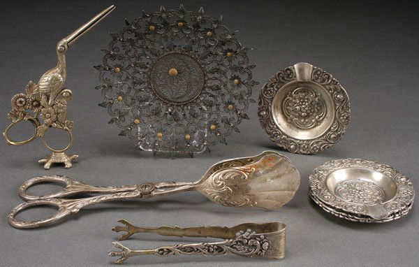 A CONTINENTAL DECORATIVE SILVER GROUP, CIRCA 1900: A CONTINENTAL DECORATIVE SILVER GROUP, CIRCA 1900 AND LATER, MOSTLY GERMAN. Comprising a novelty stork form umbilical clamp stamped 800, a possibly Norwegian coiled silver openwork cabinet plate with
