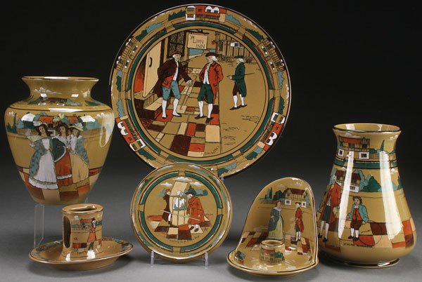 COLLECTION OF BUFFALO POTTERY, DELDARE WARE: A SIX PIECE COLLECTION OF BUFFALO POTTERY, DELDARE WARE, EARLY 20TH CENTURY. Comprising a "Lion Inn" charger, "School Master" vase, an untitled vase with three women, an untitled chamber stick, an "O