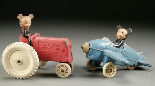 A PAIR OF MICKEY MOUSE RUBBER TOYS including "Mic: A PAIR OF MICKEY MOUSE RUBBER TOYS including "Mickey's Tractor" and "Mickey's Air Mail" (plane missing propeller). Estimate $75-$100