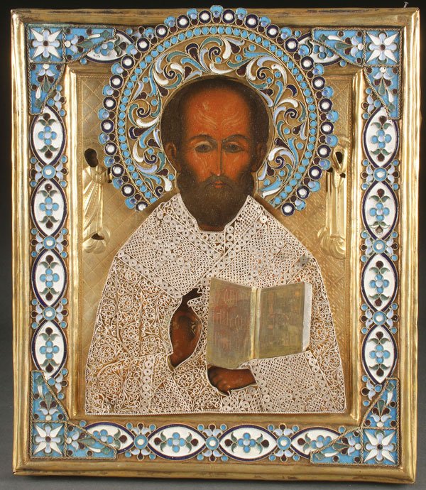 A RUSSIAN ICON OF ST. NICHOLAS, MSTERA, C. 1890: A RUSSIAN ICON OF ST. NICHOLAS, MSTERA, CIRCA 1890. Finely and traditionally painted against an olive green ground with extensive gilt highlights and overlaid with a gilded and chased brass oklad with