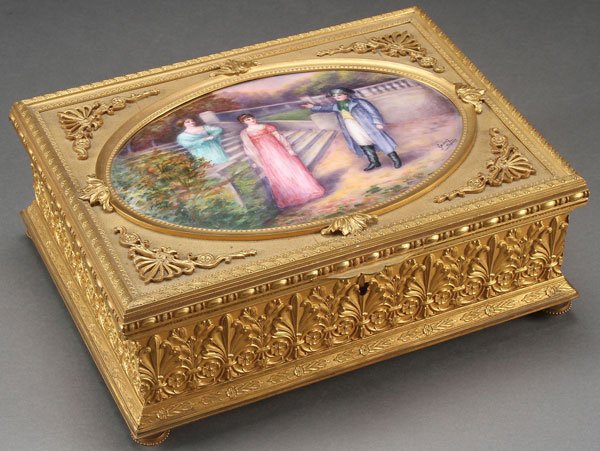 FRENCH GILT BRONZE & LIMOGES ENAMEL DRESSER BOX: A VERY FINE LARGE AND IMPRESSIVE FRENCH GILT BRONZE AND LIMOGES ENAMELED DRESSER BOX, CIRCA 1915. Resting on four bun feet, the sides banded with repeating pattern of acanthus, rosettes and holly, ben