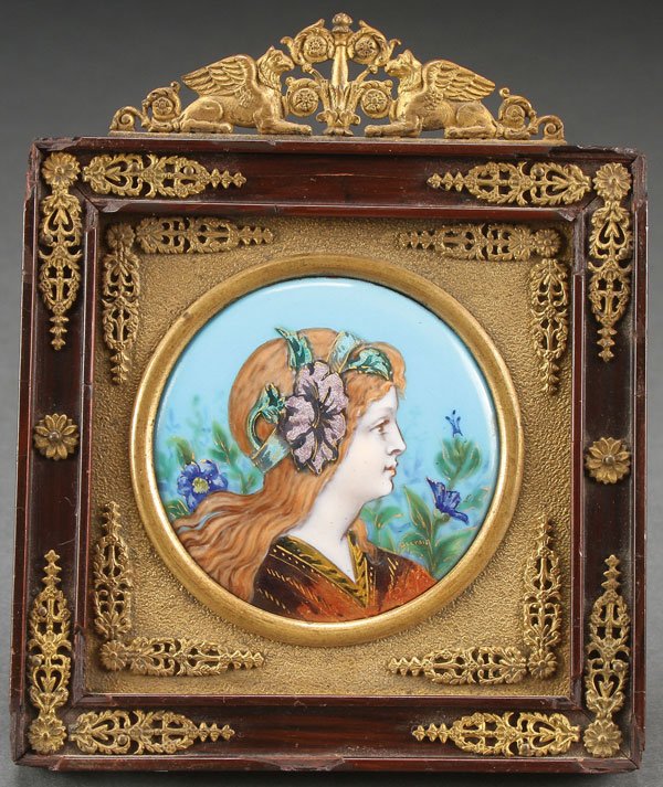 A VERY FINE FRENCH LIMOGES ENAMELED PLAQUE: A VERY FINE FRENCH LIMOGES ENAMELED PLAQUE, 19TH CENTURY. The enameled medallion depicting a bust profile of a young beauty, set in an ornate ormolu mounted frame with griffin finial. Greatest height 